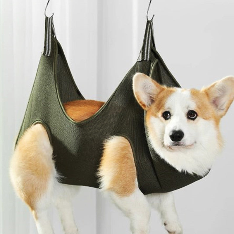 Small dog resting in the Pet Grooming Hammock during a nail trim