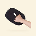 Black pet hair removal mitt worn on a hand
