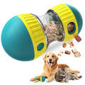 Teal and yellow treat dispensing puzzle ball with kibble, a golden retriever and a cat