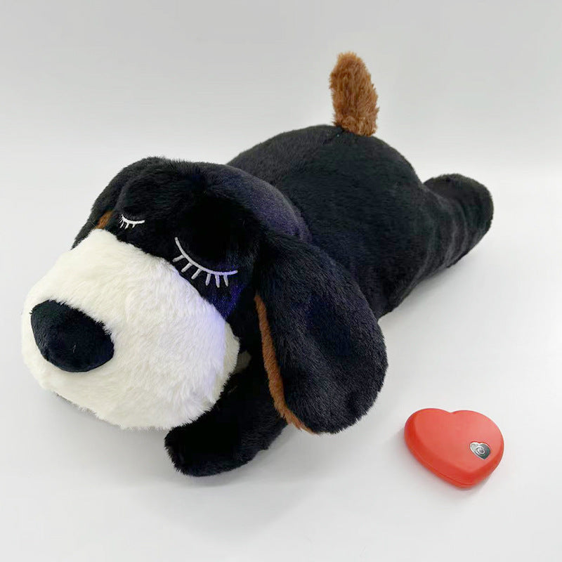 Puppy cuddling the Heartbeat Calming Puppy Plush