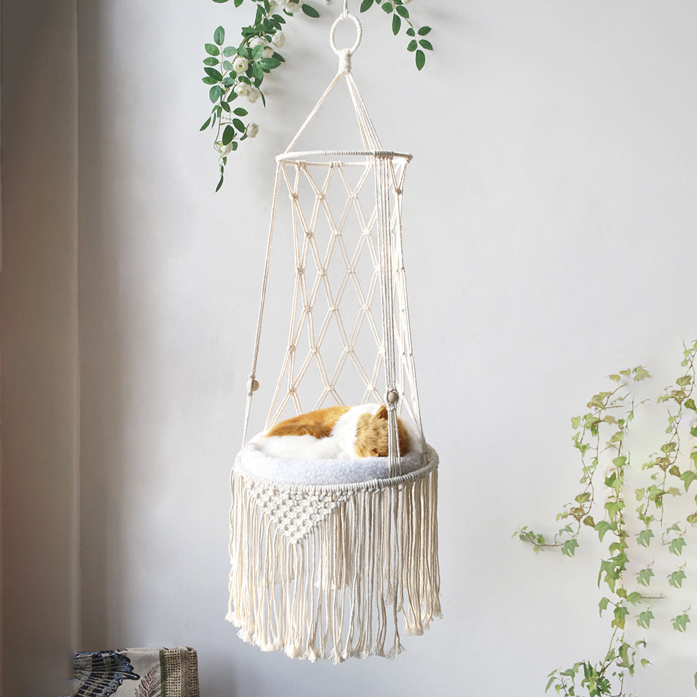 Cat lounging in the Macrame Hanging Cat Bed