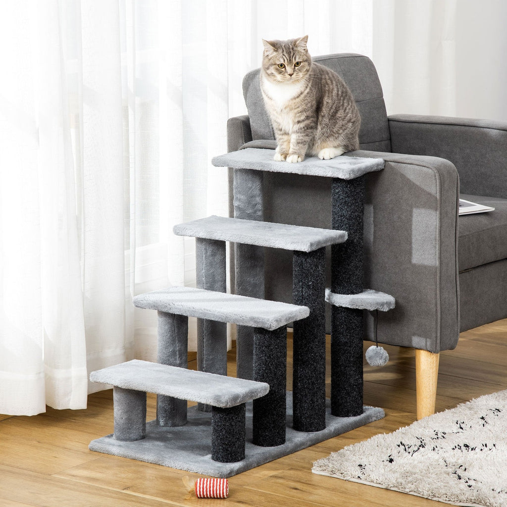 Grey four-step carpeted cat staircase beside an armchair with a cat sitting on top