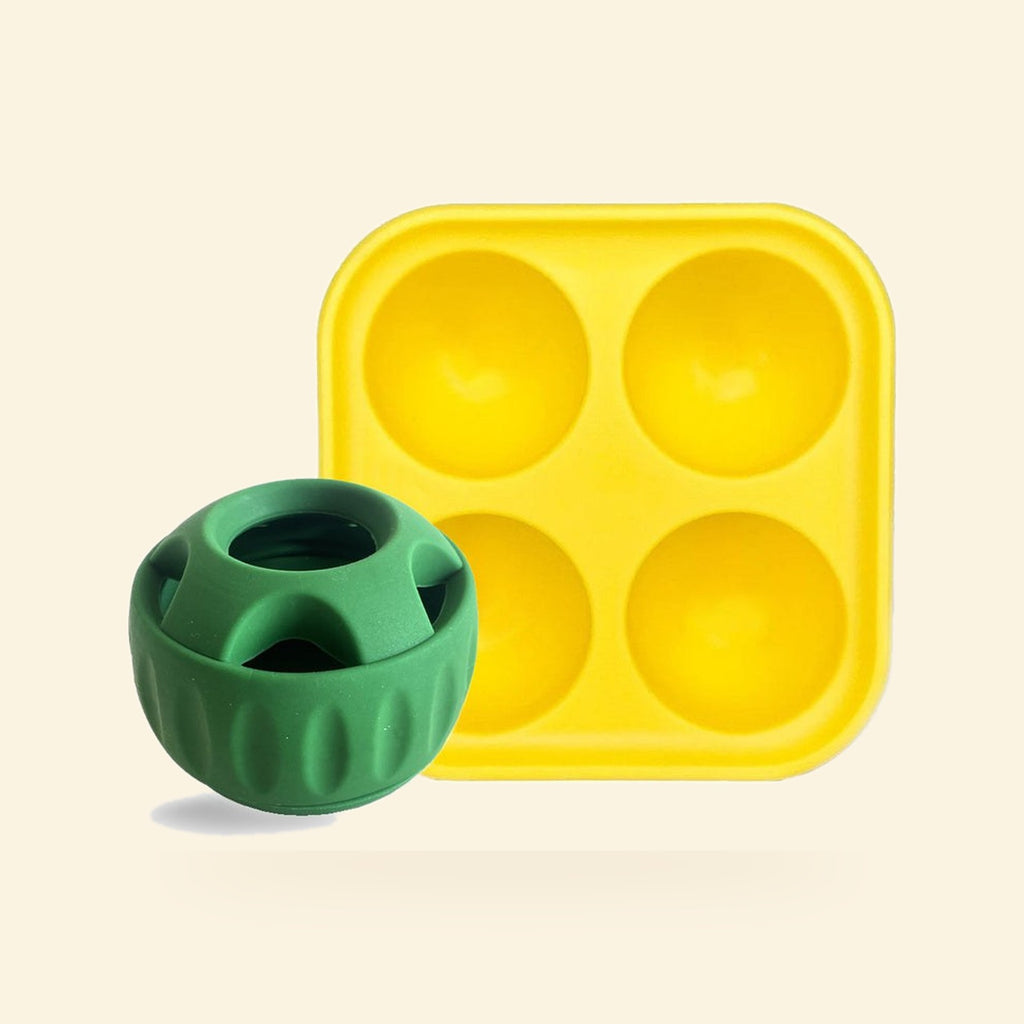 Green silicone treat ball with a yellow lick tray on a cream background